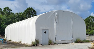 enclosed fabric structure with entry and bay doors
